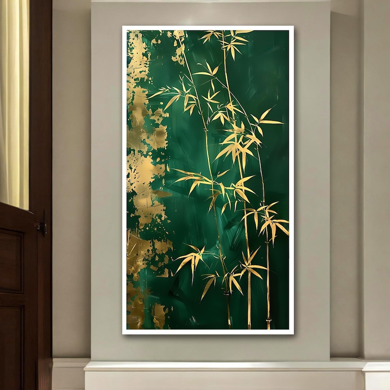 May include: An abstract painting featuring gold bamboo stalks and leaves against a deep emerald green background. Gold paint splatters add texture and contrast to the artwork. The painting is framed in a white border.
