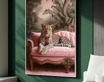 May include: A framed art print featuring a leopard resting on a pink, ornate sofa. The leopard has a spotted coat and is the focal point of the image. The background depicts a lush, tropical landscape with trees and foliage, creating a serene atmosphere.