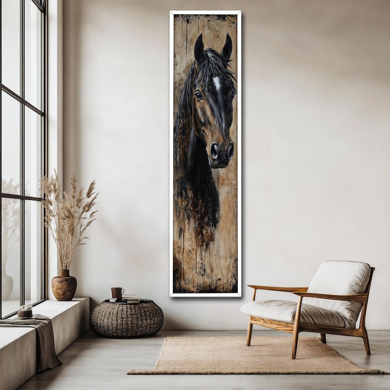 May include: A vertical framed painting of a horse's head. The horse has a dark brown coat with a white marking on its forehead. The background has a textured, neutral colour palette, with a white frame. The artwork is displayed in a modern living space.
