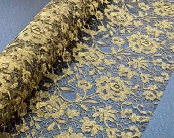 May include: A roll of metallic gold lace fabric featuring a detailed floral pattern. The intricate design consists of interconnected roses and leaves woven into a fine, semi-sheer mesh structure, showcasing a consistent golden sheen throughout.
