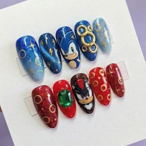 May include: A white ceramic mug with a black handle and the text "But First, Coffee" in a black, bold font. The mug is on a white surface.