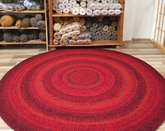 Handmade round rug in red, measures 59'' in diameter