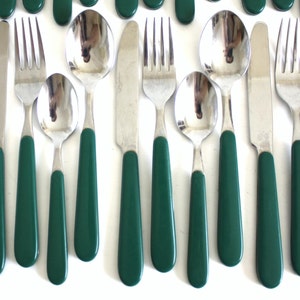 May include: A set of green handled silverware, including a fork, knife, and spoon. The silverware is made of stainless steel and has a polished finish.