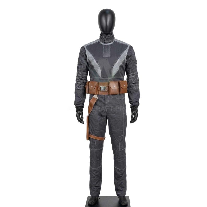 May include: A dark gray jumpsuit with a high collar, accented with lighter gray panels and stitching. The costume includes a brown leather belt with pouches and a holster. Black gloves and boots complete the outfit.