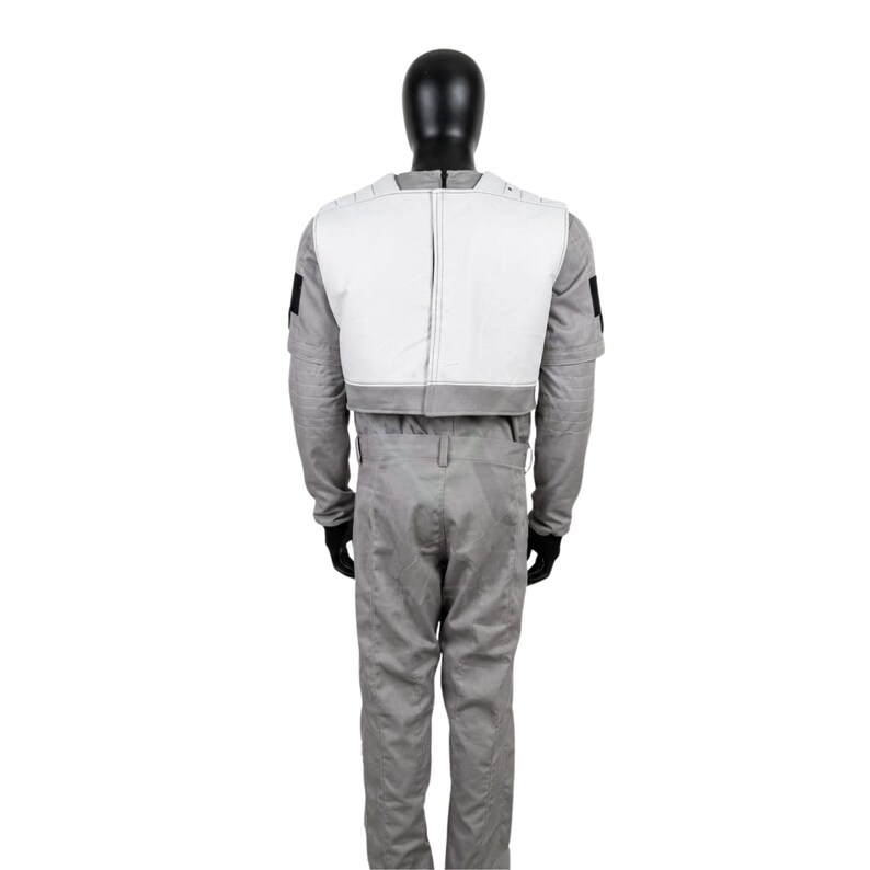 May include: A full-body costume set featuring a light gray long-sleeved shirt and matching trousers. A white vest with a gray bottom border is worn over the shirt. The outfit is displayed on a black mannequin, showing the back view of the ensemble.