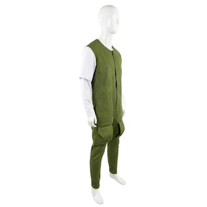 May include: A green jumpsuit with a sleeveless top and long trousers, featuring large pockets on the legs. The jumpsuit is worn over a white long-sleeved shirt. The mannequin is against a white background.