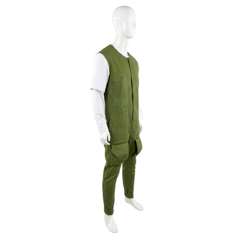 May include: A green jumpsuit with a sleeveless top and long trousers, featuring large pockets on the legs. The jumpsuit is worn over a white long-sleeved shirt. The mannequin is against a white background.