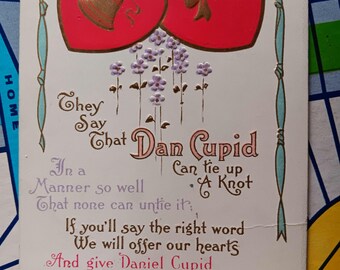 Dicen que Dan Cupid sabe hacer un nudo - Postal antigua de 1916