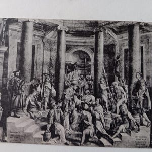 May include: Black and white print of a historical scene with numerous figures in classical attire. The artwork depicts a gathering in a grand, columned structure, with detailed architectural elements and figures engaged in various activities. The print has text at the bottom.