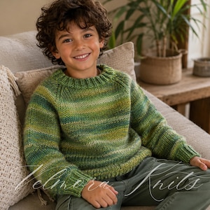 May include: A green and yellow striped knit sweater with a crew neck. The sweater is worn by a child. The text "Velmora Knits" is visible in the lower right corner. The child is wearing green pants.