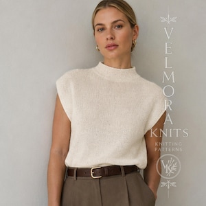 Può includere: Un top in maglia color crema senza maniche con collo alto, abbinato a pantaloni marrone scuro con una cintura con fibbia color oro. L'immagine include il testo verticale VELMORA KNITS KNITTING PATTERNS e un logo grafico circolare.