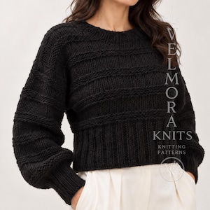 May include: A black long-sleeved jumper featuring a textured knit pattern with horizontal bands of garter stitch and stockinette stitch. The garment has a round neckline and a wide ribbed hem. The text VELMORA KNITS KNITTING PATTERNS is visible.
