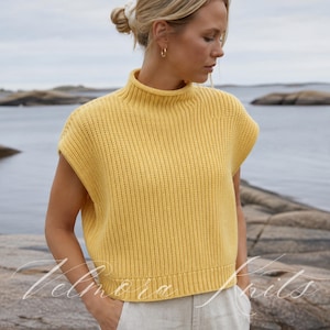May include: A bright yellow sleeveless sweater vest featuring a ribbed knit texture and a high mock neck collar. The garment has a straight hemline and wide arm openings, crafted with a consistent vertical knit pattern throughout the body.