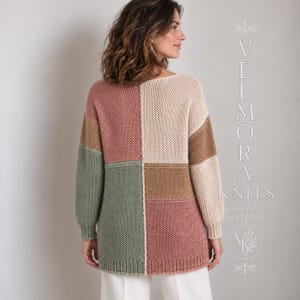 May include: A long-sleeved knit jumper featuring a colour-blocked design in shades of dusty rose, cream, tan, and sage green. The garment has a ribbed hem and cuffs, with the text VELMORA KNITS KNITTING PATTERNS visible on the right side.