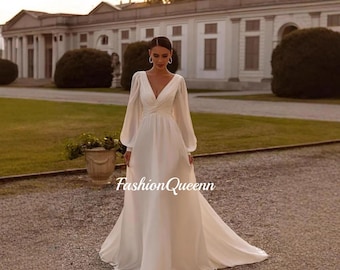 Vestido de novia de satén, moderno y de alta gama, con mangas largas, escote en V profundo, espalda descubierta y cola fluida.