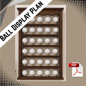 May include: A dark wood golf ball display plan with multiple shelves, each holding golf balls on tees. The text "BALL DISPLAY PLAN" is diagonally across the top left. A PDF icon is in the bottom right.