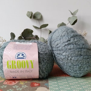 May include: Two balls of light blue yarn labelled "DMC GROOVY MADE IN ITALY".
