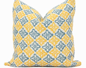 May include: A yellow and blue patterned throw pillow with a geometric design. The pillow is made of a soft, comfortable fabric and is perfect for adding a touch of color and style to any room.