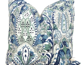 May include: A decorative throw pillow with a blue and green paisley pattern on a white background.