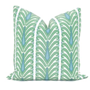 May include: A green and blue patterned throw pillow with a white background. The pattern features a repeating design of stylized leaves and teardrop shapes.