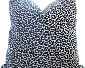 May include: A blue and white leopard print throw pillow. The pillow is made of a soft, plush fabric and has a subtle sheen.