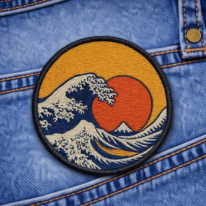 May include: A set of three ceramic mugs with a speckled, cream-colored glaze. Each mug features a different hand-painted floral design in shades of blue, green, and yellow. The mugs have a simple, rounded shape and a comfortable handle.