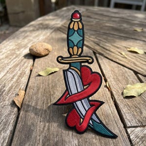 May include: A handmade, wooden cutting board with a natural finish. The board features a juice groove and a handle for easy carrying. Dimensions are approximately 18 inches long, 12 inches wide, and 1 inch thick.