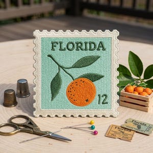 May include: A square embroidered patch shaped like a postage stamp with a light green background, featuring the text FLORIDA, a dark green leafy orange branch, and the number 12 in dark green. The border is cream-colored with a scalloped edge.