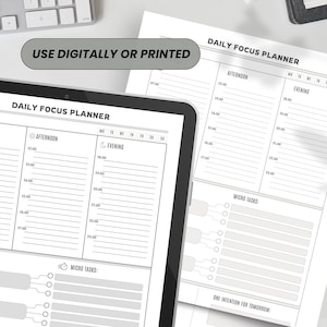 A digital tablet and printed planner with a daily focus layout. The planner includes sections for afternoon and evening schedules, micro tasks, and a space for a daily intention. The text "USE DIGITALLY OR PRINTED" is displayed.