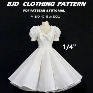 May include: A white doll dress with a bow detail and puffed sleeves. The dress is designed for a 1/4 BJD doll, 40-45cm in height. Text on the image reads "BJD CLOTHING PATTERN" and "PDF PATTERN & TUTORIAL".
