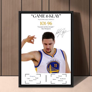 May include: Framed print featuring Klay Thompson in a Golden State Warriors jersey. The print includes the text "GAME 6 KLAY", the score 101-96, and a quote by Thompson. The jersey has blue and yellow accents, with the Golden State logo.