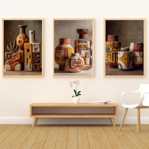 May include: Three framed art prints featuring abstract pottery designs in warm earth tones. The pottery includes vases and geometric shapes with textured surfaces. The frames are a light wood color, and the overall aesthetic is rustic and artistic.