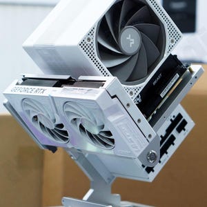 May include: A white computer case with a GeForce RTX graphics card and a large fan. The case has a unique, angular design with a silver stand. The fan is gray and black. The text "BEAST" is visible on a black component.