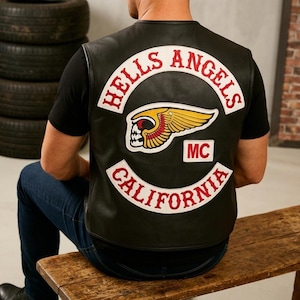 May include: Black leather vest with the "HELLS ANGELS CALIFORNIA MC" patch on the back. The patch features a skull with wings and the words "HELLS ANGELS" in a curved red font.