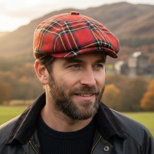 May include: A red plaid newsboy cap with a rounded crown and a short brim. The cap features a classic tartan pattern in red, green, yellow, and blue. The cap is made of a soft, textured fabric and is suitable for fall and winter wear.