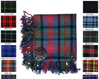 May include: A tartan scarf with a blue, green, and red plaid pattern, fringed edges, and a decorative metal brooch. The image includes a variety of tartan swatches and text that reads "Available in 50+ Tartans."