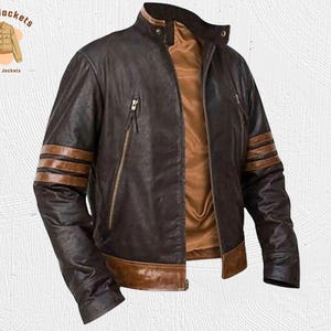 May include: A brown leather jacket with a stand-up collar and multiple zipper pockets. The jacket features brown stripes on the sleeves and a brown trim at the bottom. The interior lining is a lighter brown color. The logo "Kraft Jackets" is in the upper left corner.