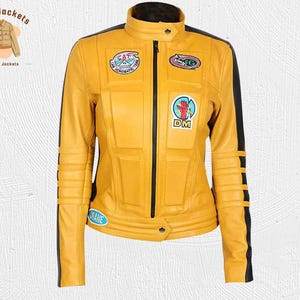 May include: Yellow leather jacket with black accents, a stand-up collar, and a front zipper. The jacket features multiple patches, including a hand graphic and the text "DM". The sleeves have black stripes. The brand logo "Kraft Jackets" is in the upper left corner.