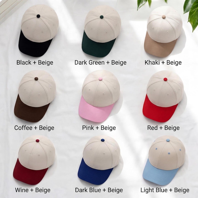 May include: A selection of nine beige baseball caps, each with a different coloured peak and button. The peak colours are black, dark green, khaki, coffee, pink, red, wine, dark blue, and light blue. Text labels identify each colour combination.