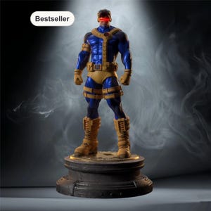 May include: A detailed figurine of a superhero, featuring a blue and yellow costume with a red visor. The figure stands on a decorative base. The word "Bestseller" is in a white oval in the upper left corner.