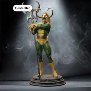 May include: A detailed statue of a comic book character, wearing a green and yellow costume with a golden helmet and horns. The figure is holding a silver staff with a unique head. The statue is on a stone-like base, with a "Bestseller" label.