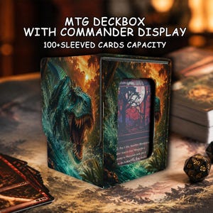 May include: A rectangular MTG deckbox with a commander display window, featuring a printed dinosaur graphic in a jungle setting. The text reads MTG DECKBOX WITH COMMANDER DISPLAY and 100+ SLEEVED CARDS CAPACITY. It is designed to hold over 100 sleeved cards.
