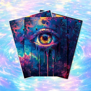 May include: A stack of art prints featuring a vibrant, surreal eye design. The eye is detailed with shades of orange, yellow, and brown, set against a backdrop of blues, purples, and pinks. The artwork has a psychedelic, cosmic theme.