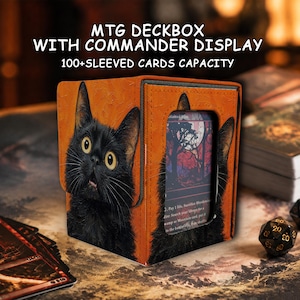 May include: An orange deck box for trading cards featuring a black cat illustration and a clear display window for a commander card. The text reads MTG DECKBOX WITH COMMANDER DISPLAY 100+ SLEEVED CARDS CAPACITY. The box has a textured surface.