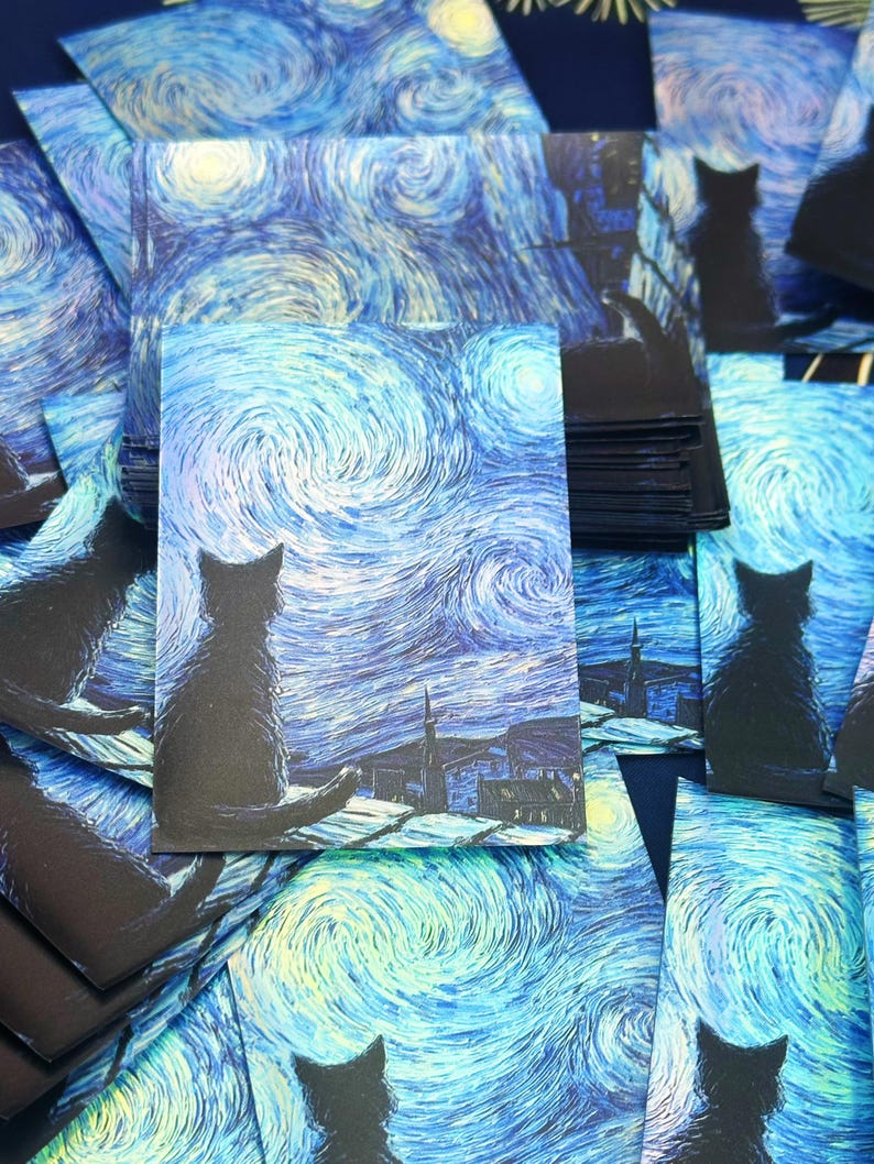 May include: A stack of rectangular postcards featuring a dark silhouette of a cat sitting on a roof, overlooking a swirling blue and yellow night sky inspired by Van Gogh's Starry Night. The artwork displays thick, textured brushstrokes.