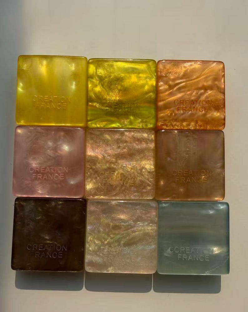 May include: Nine square-shaped decorative items in various colors, including yellow, gold, orange, pink, brown, and green. Each item has a pearlescent finish and the text "CREATION FRANCE" printed on it.