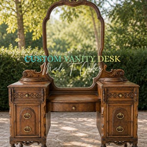 May include: A custom-made wooden vanity desk with an oval mirror. The desk has two side cabinets with drawers and ornate brass handles. The text "CUSTOM VANITY DESK Made To Order" is displayed on the image. The desk is made of dark wood.