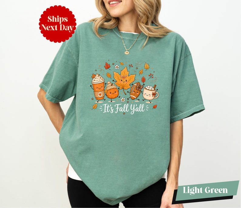 A woman wearing a green t-shirt with a graphic design of cartoon characters and text.
