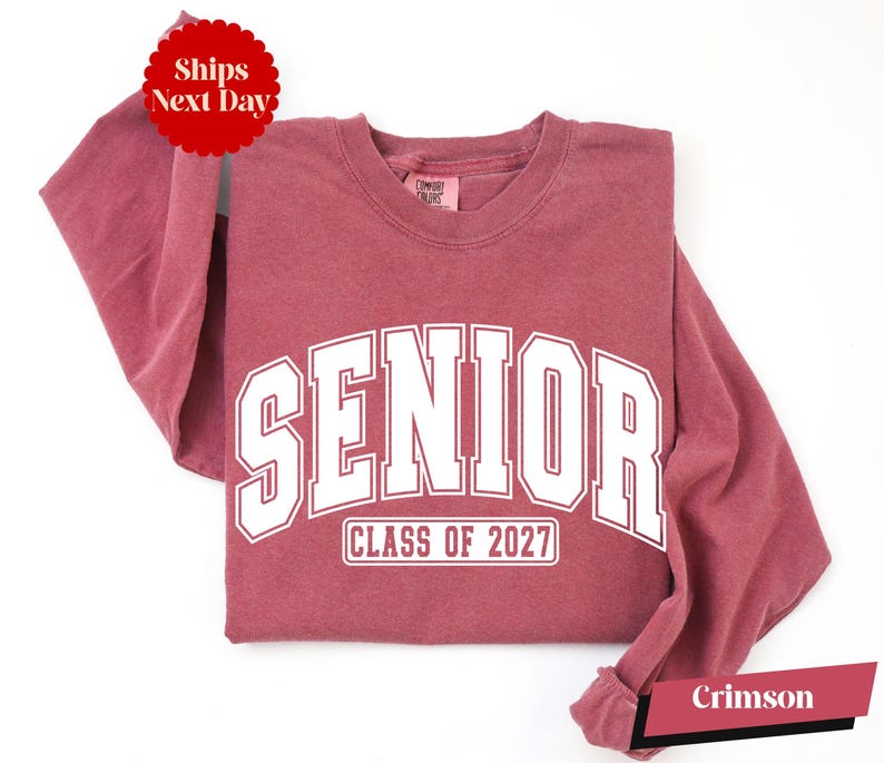 A red long-sleeved t-shirt with white text that says "SENIOR CLASS OF 2027" printed on it.