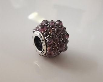May include: A spherical charm bead featuring a textured surface covered in numerous small, translucent purple glass spheres. The silver core is engraved with the text S925 ALE, indicating sterling silver composition and the brand name.